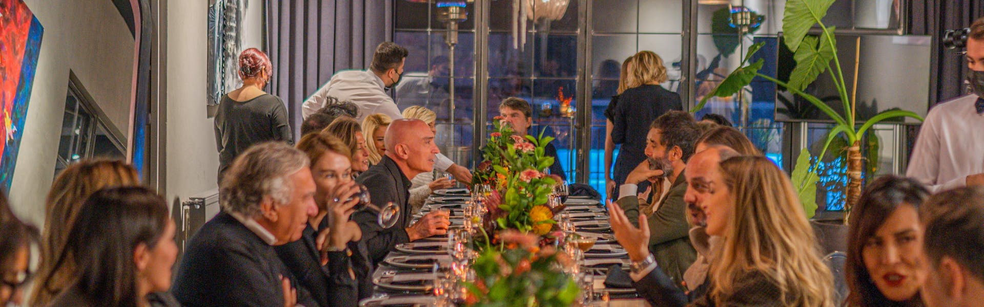 Elegant formal gala dinner with well-dressed guests at upscale venue - LuxRide special events transportation