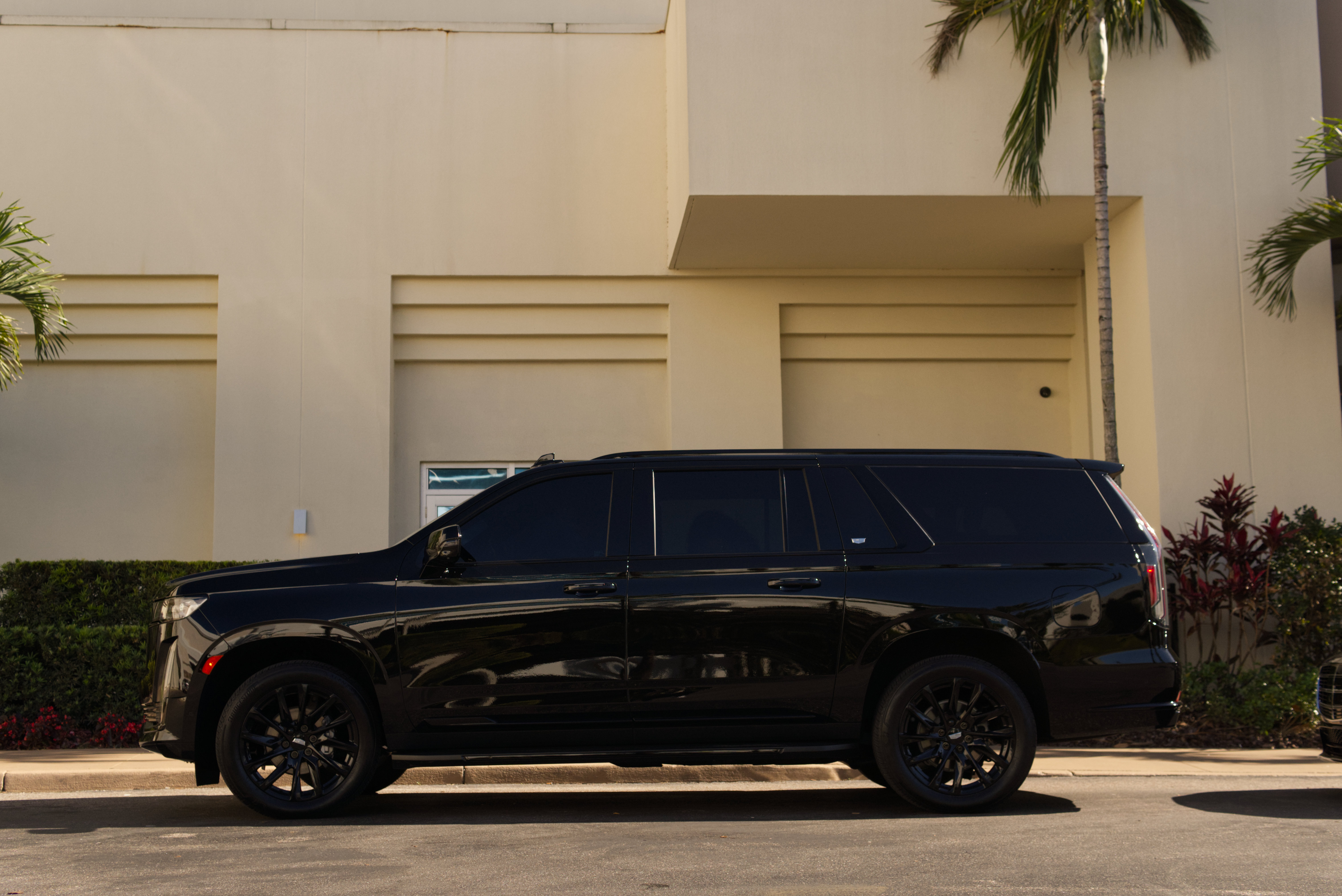 Black Cadillac Escalade side profile - LuxRide luxury SUV service