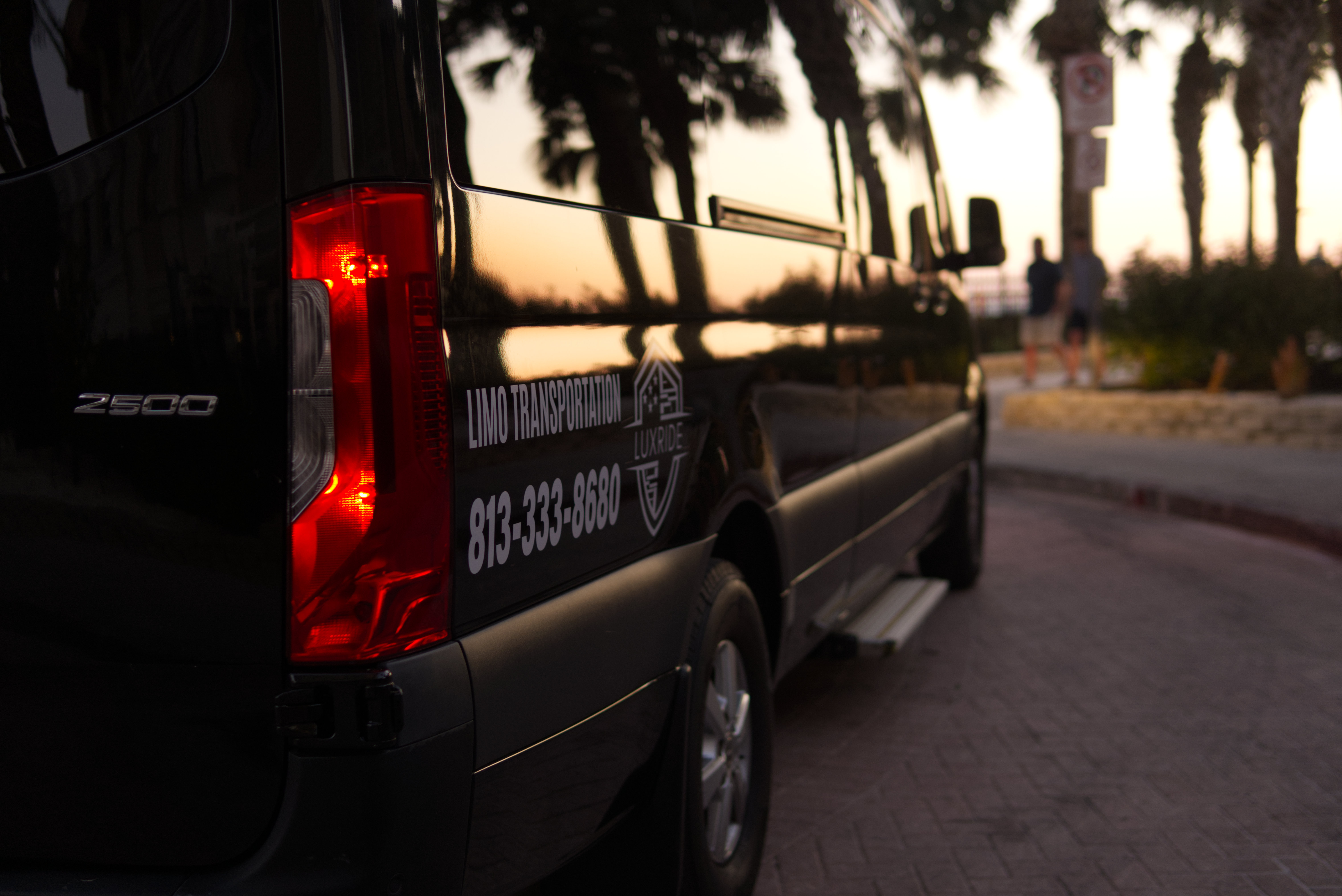Mercedes Sprinter badge closeup at dusk - LuxRide Tampa Bay chauffeur service