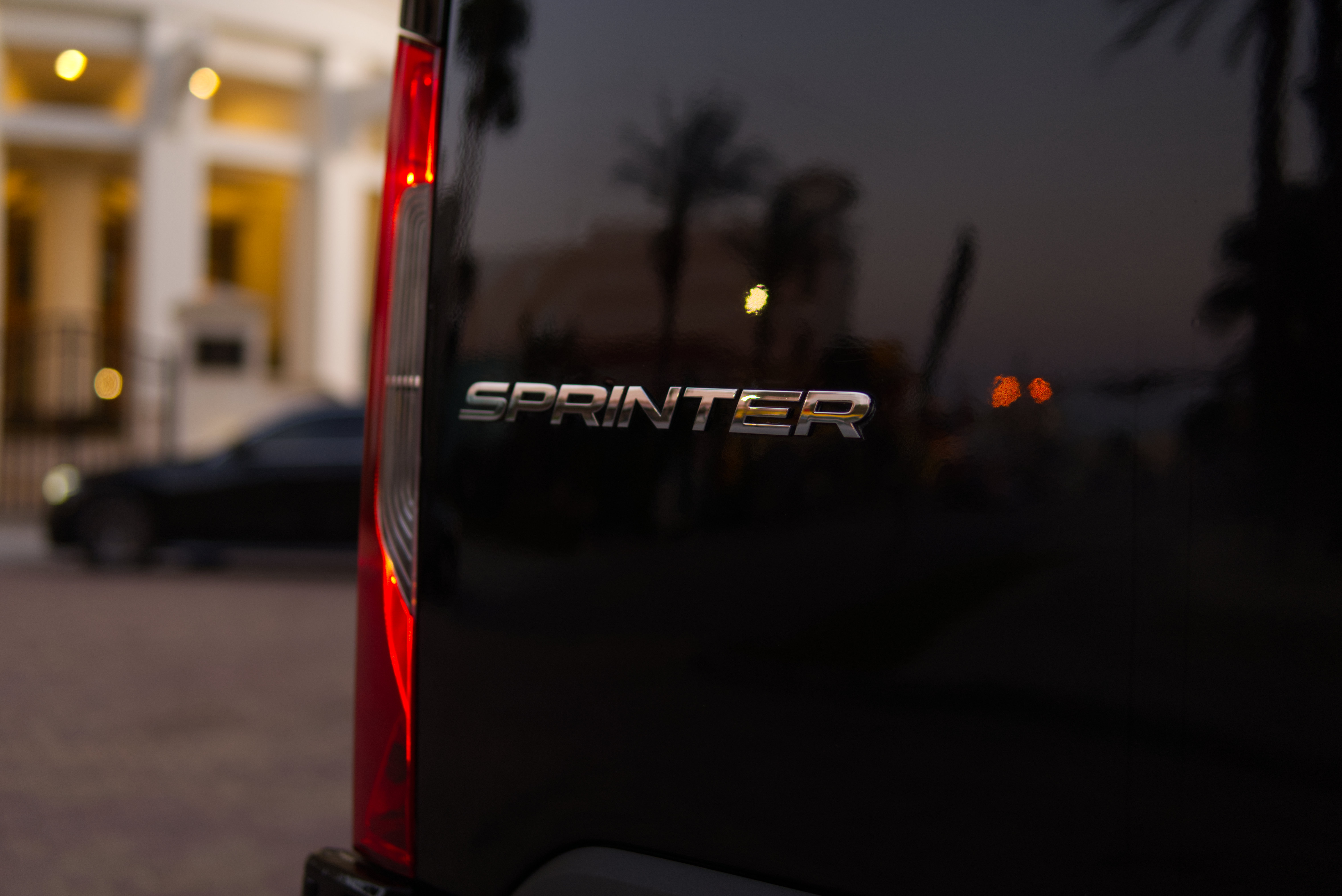 Mercedes Sprinter front grille and headlight detail - LuxRide luxury van service