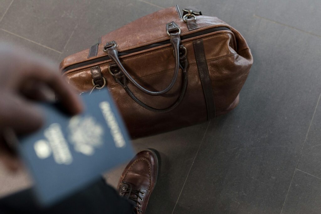 Airport Transfer a person holding a passport and a brown bag