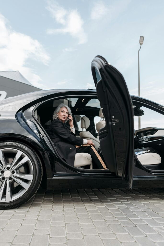 Hourly / As-Directed Service a woman sitting in a car with her door open